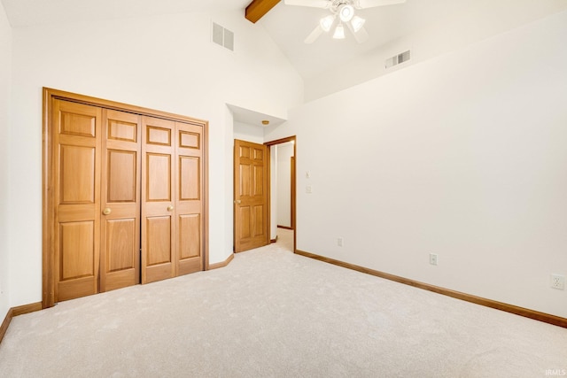 unfurnished bedroom with beam ceiling, ceiling fan, a closet, and carpet floors