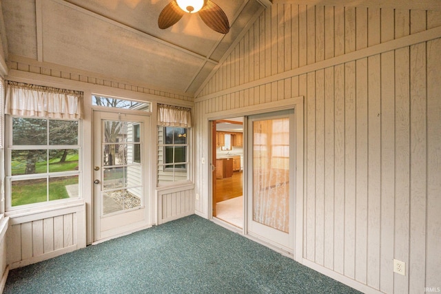 unfurnished sunroom with ceiling fan and vaulted ceiling