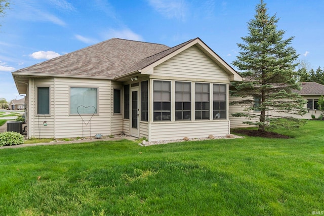 back of house with a yard, a sunroom, and central air condition unit