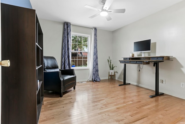 living area with light wood-type flooring and ceiling fan