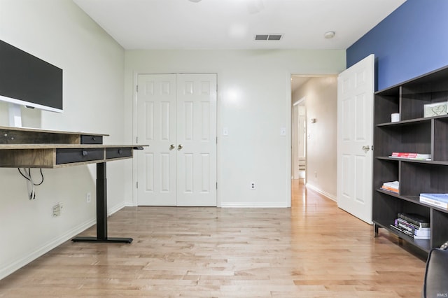 unfurnished office featuring light wood-type flooring