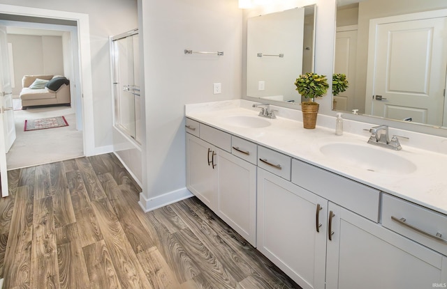 bathroom with hardwood / wood-style floors and vanity