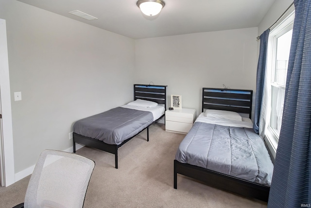 bedroom with light colored carpet