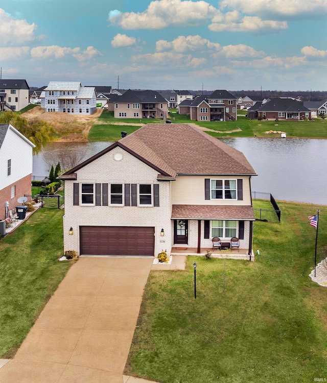 view of front of property with a front yard, a water view, a garage, and cooling unit