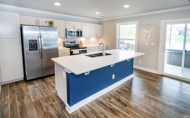 kitchen featuring white cabinets, appliances with stainless steel finishes, a center island with sink, and a healthy amount of sunlight