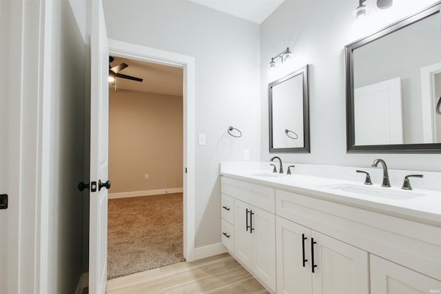 bathroom with hardwood / wood-style floors, vanity, and ceiling fan