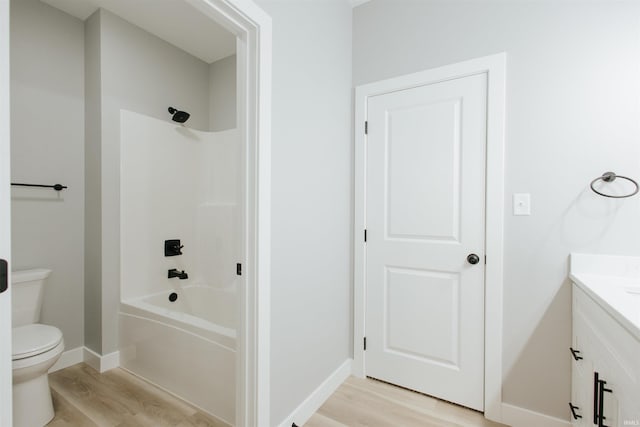 full bathroom featuring toilet, vanity, shower / bath combination, and hardwood / wood-style flooring