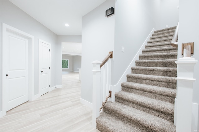 stairs featuring hardwood / wood-style flooring