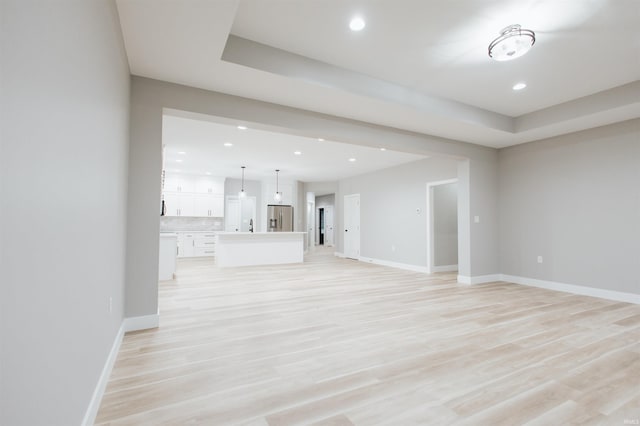 unfurnished living room featuring light wood-type flooring