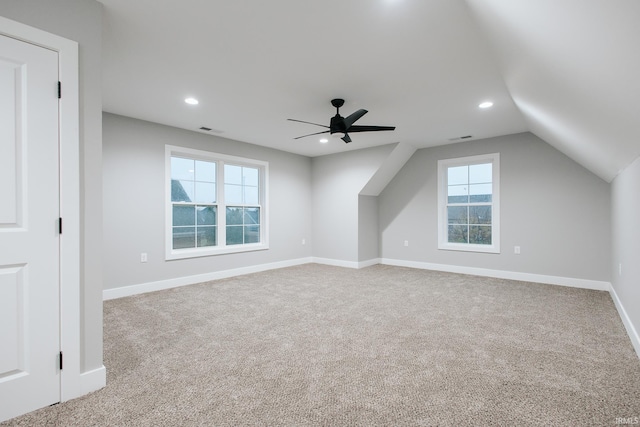 bonus room featuring plenty of natural light, ceiling fan, light colored carpet, and lofted ceiling