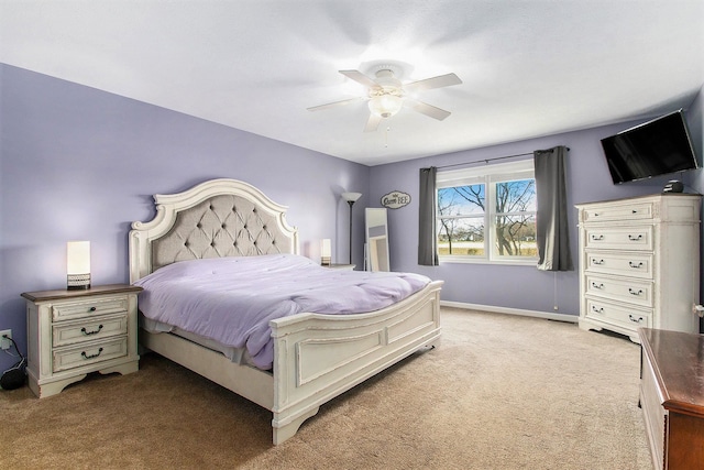 bedroom with ceiling fan and light colored carpet