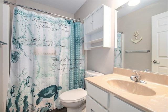 bathroom with vanity, curtained shower, and toilet