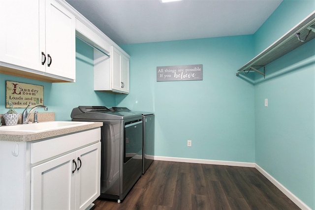 laundry room featuring sink, cabinets, dark hardwood / wood-style floors, and independent washer and dryer