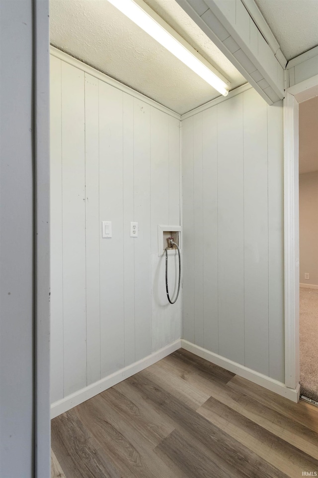 washroom with hardwood / wood-style floors and washer hookup