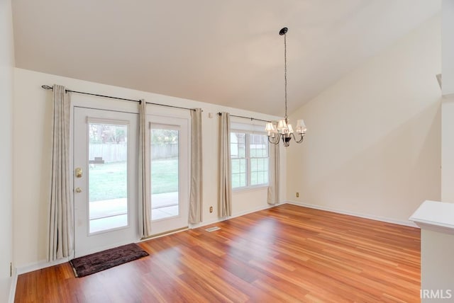 interior space featuring a wealth of natural light, lofted ceiling, and hardwood / wood-style flooring