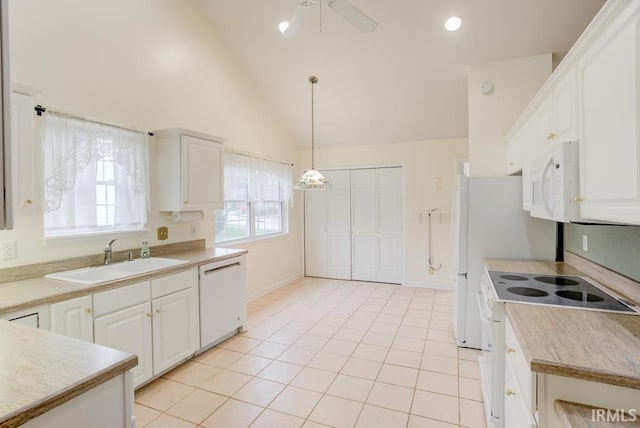 kitchen featuring pendant lighting, white appliances, high vaulted ceiling, sink, and white cabinetry