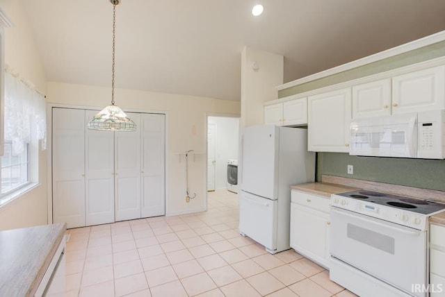 kitchen featuring pendant lighting, white appliances, white cabinets, light tile patterned floors, and washer / dryer