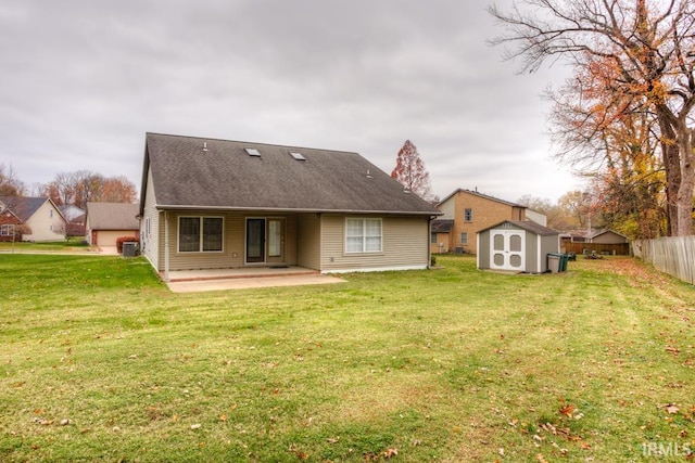 rear view of house with a storage unit, a yard, and a patio