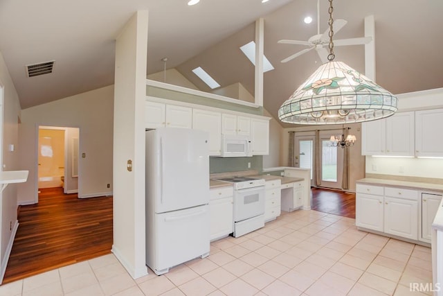 kitchen with white cabinets, light hardwood / wood-style floors, white appliances, and high vaulted ceiling