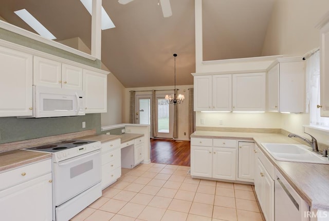 kitchen featuring pendant lighting, white cabinetry, white appliances, and sink