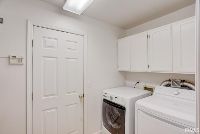 laundry room with cabinets and washer and clothes dryer