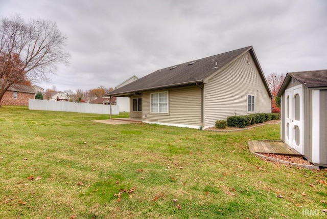 rear view of house with a patio, a storage shed, and a lawn