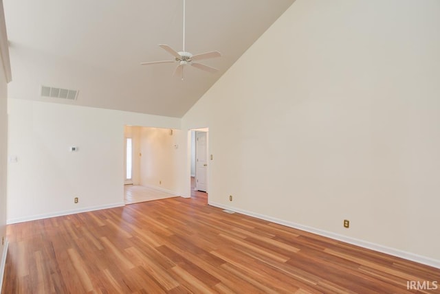 empty room featuring light hardwood / wood-style flooring, high vaulted ceiling, and ceiling fan