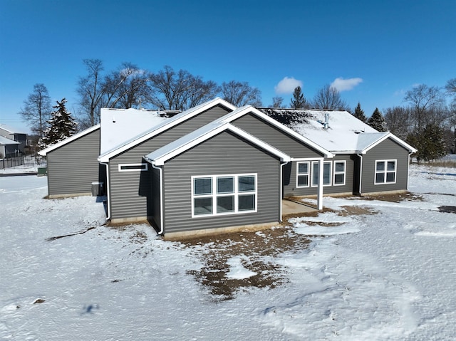 view of snow covered back of property