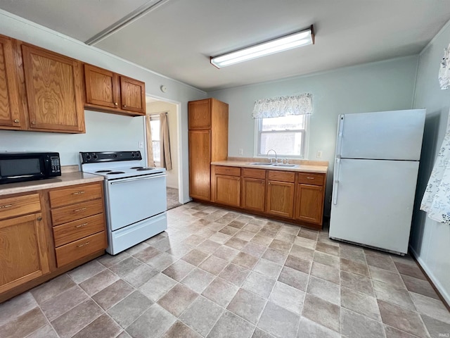 kitchen featuring white appliances and sink