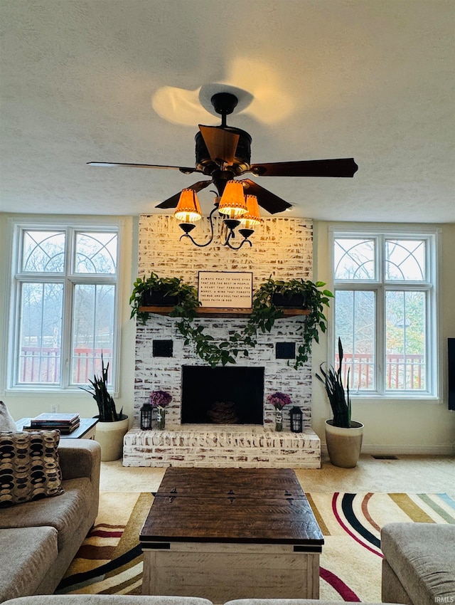 living room with carpet flooring, a wealth of natural light, and a textured ceiling