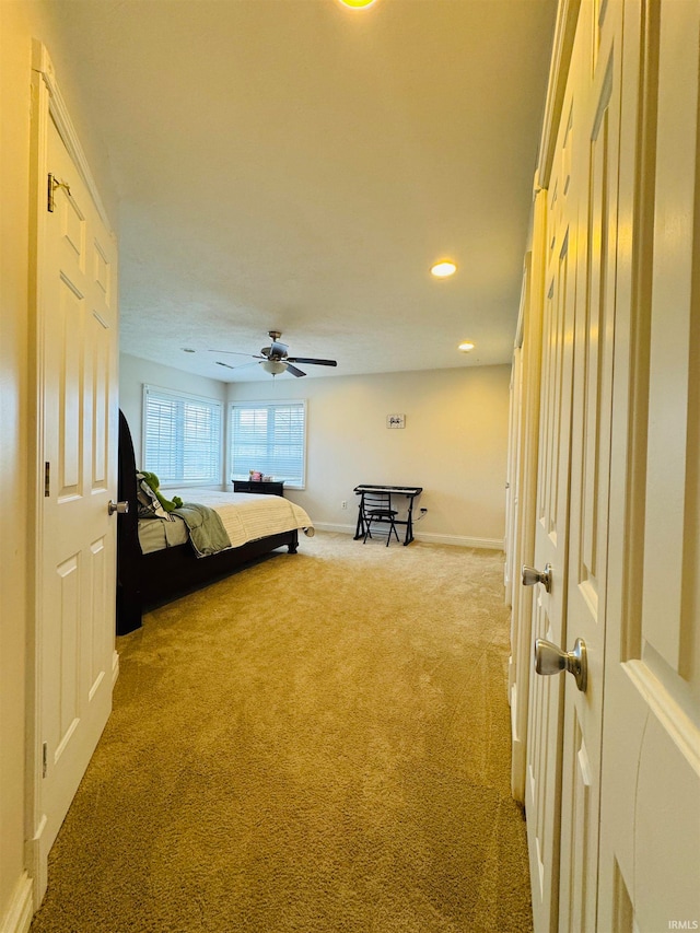 unfurnished bedroom featuring ceiling fan and carpet