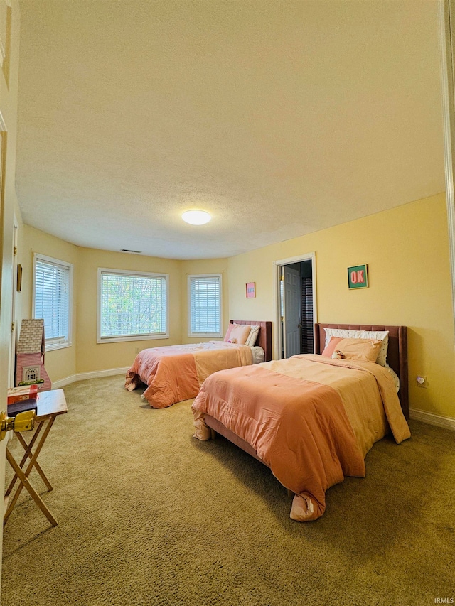 bedroom featuring carpet flooring and a textured ceiling