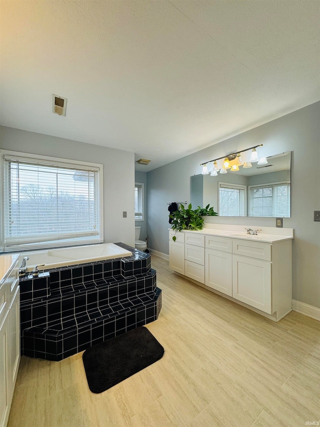 bathroom featuring a tub to relax in, hardwood / wood-style floors, and vanity