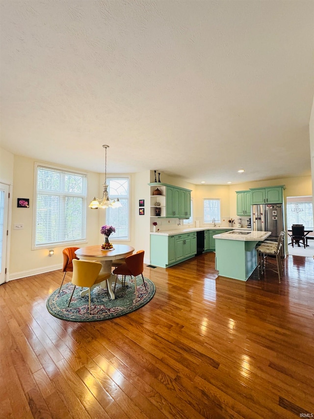 dining space with dark wood-type flooring and a notable chandelier