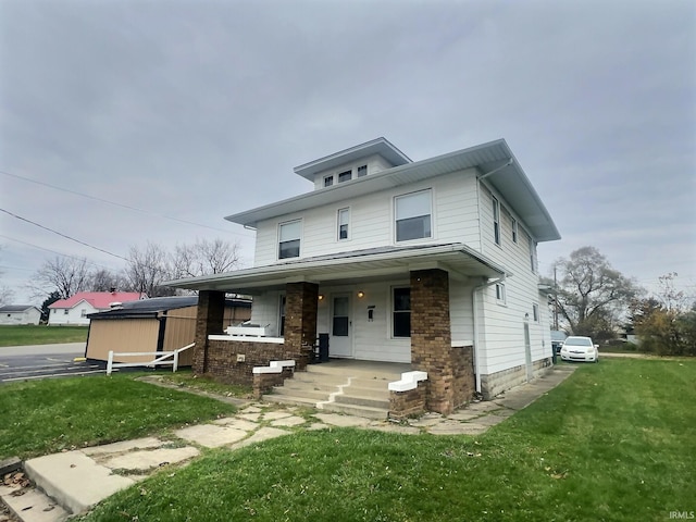 view of front of house with covered porch and a front yard