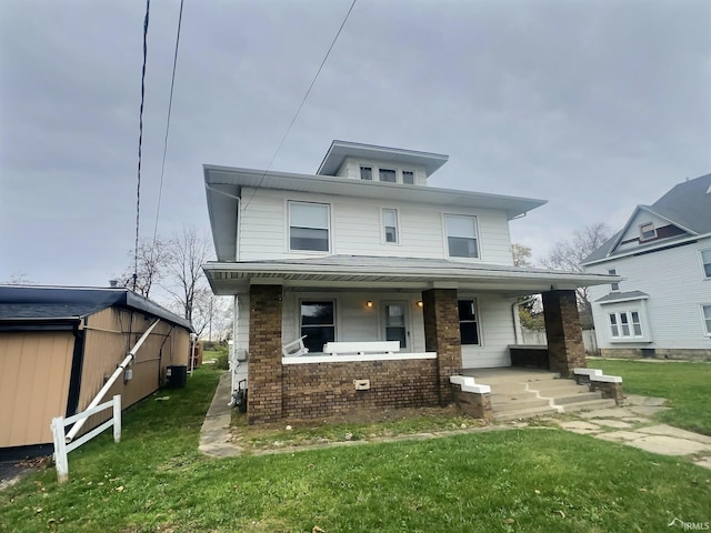 view of front facade with a porch, central air condition unit, and a front lawn