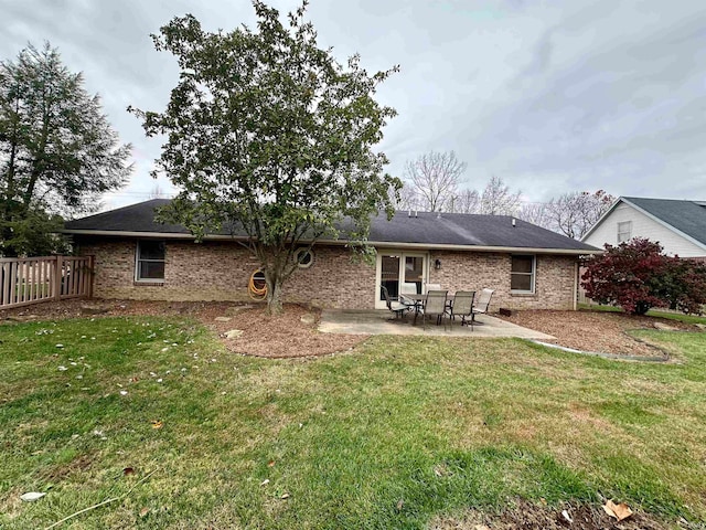 rear view of property with a lawn and a patio area