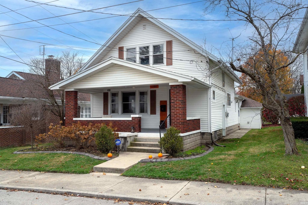 bungalow-style home featuring a porch and a front yard