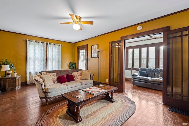 living room featuring ceiling fan, wood-type flooring, and ornamental molding