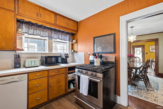 kitchen with gas range, dishwasher, dark wood-type flooring, a textured ceiling, and decorative light fixtures