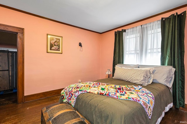 bedroom with dark hardwood / wood-style flooring and ornamental molding