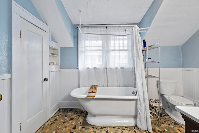 bathroom featuring a textured ceiling, vanity, and toilet