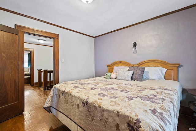 bedroom with hardwood / wood-style flooring and ornamental molding