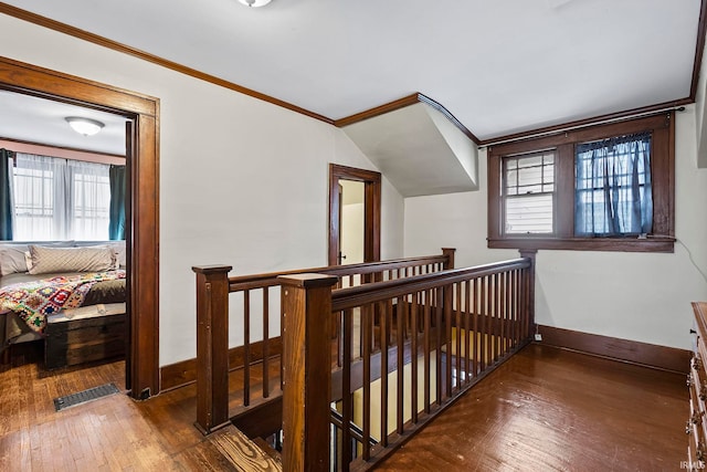 hall with dark hardwood / wood-style flooring, crown molding, and a wealth of natural light