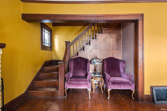 living area featuring hardwood / wood-style flooring and crown molding