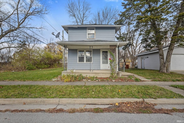 view of front facade with a porch, a garage, an outdoor structure, and a front lawn