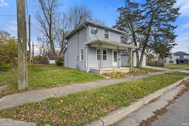 view of front of house featuring covered porch and a front yard