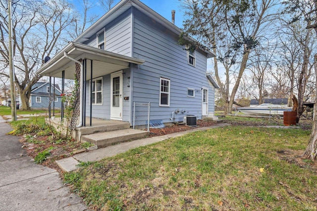 exterior space with a lawn and central AC unit