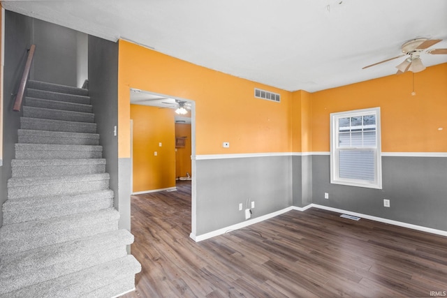 stairs with hardwood / wood-style flooring and ceiling fan