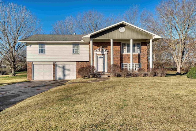 split foyer home featuring a garage and a front lawn